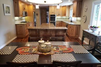 Large french country galley medium tone wood floor and brown floor eat-in kitchen photo in Other with a double-bowl sink, beaded inset cabinets, light wood cabinets, granite countertops, white backsplash, ceramic backsplash, stainless steel appliances, an island and multicolored countertops