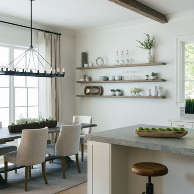 Eat-in kitchen - large transitional l-shaped light wood floor and brown floor eat-in kitchen idea in Atlanta with an island, an undermount sink, shaker cabinets, white cabinets, gray backsplash, porcelain backsplash, stainless steel appliances and limestone countertops