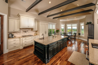 Inspiration for a mid-sized timeless medium tone wood floor and brown floor eat-in kitchen remodel in Other with an undermount sink, raised-panel cabinets, black cabinets, granite countertops, paneled appliances and an island