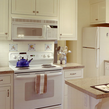 Custom built white cabinets with inset doors and drawers