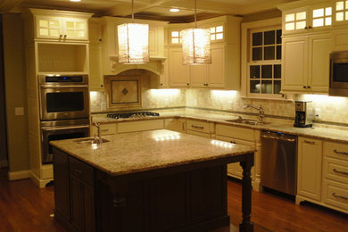 Example of a classic kitchen design in Nashville with raised-panel cabinets, white cabinets, granite countertops and an island