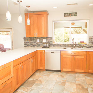 Mid-sized southwestern eat-in kitchen inspiration - Example of a mid-sized southwest u-shaped porcelain tile eat-in kitchen design in Los Angeles with an undermount sink, shaker cabinets, light wood cabinets, quartzite countertops, multicolored backsplash, mosaic tile backsplash, stainless steel appliances and a peninsula