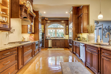 Example of a large classic u-shaped open concept kitchen design in Jacksonville with dark wood cabinets, granite countertops, stainless steel appliances and an island