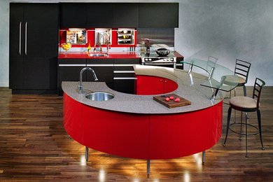 Eat-in kitchen - mid-sized modern u-shaped medium tone wood floor eat-in kitchen idea in New York with a drop-in sink, flat-panel cabinets, dark wood cabinets, quartz countertops, red backsplash, glass tile backsplash, stainless steel appliances and an island