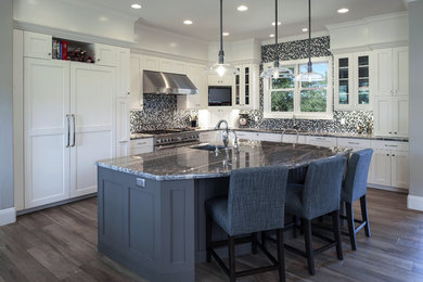 Eat-in kitchen - large transitional l-shaped ceramic tile and brown floor eat-in kitchen idea in Phoenix with a single-bowl sink, shaker cabinets, white cabinets, granite countertops, blue backsplash, mosaic tile backsplash, stainless steel appliances and an island