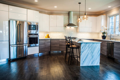 Example of a mid-sized trendy u-shaped dark wood floor eat-in kitchen design in DC Metro with a drop-in sink, flat-panel cabinets, white cabinets, marble countertops, white backsplash, glass tile backsplash, stainless steel appliances and an island