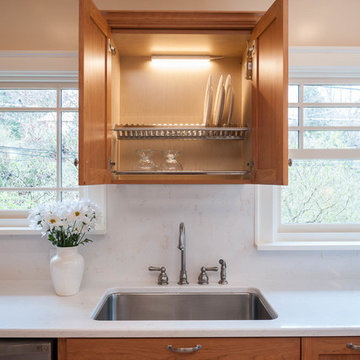 Custom, in-cabinet dish drying rack.  Water drips directly into the sink.