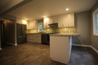 Minimalist linoleum floor and gray floor eat-in kitchen photo in Other with a drop-in sink, shaker cabinets, white cabinets, laminate countertops and glass tile backsplash