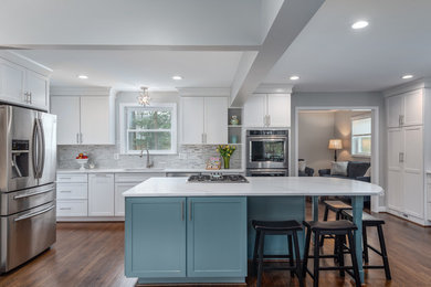 Large transitional l-shaped dark wood floor and brown floor kitchen photo in DC Metro with an undermount sink, shaker cabinets, white cabinets, quartzite countertops, multicolored backsplash, matchstick tile backsplash, stainless steel appliances, an island and white countertops