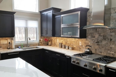 Mid-sized trendy l-shaped gray floor eat-in kitchen photo in Detroit with an undermount sink, shaker cabinets, dark wood cabinets, stainless steel appliances, marble countertops, gray backsplash, stone tile backsplash, an island and white countertops