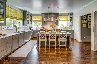 Large elegant u-shaped dark wood floor and brown floor eat-in kitchen photo in New York with an undermount sink, recessed-panel cabinets, gray cabinets, marble countertops, white backsplash, subway tile backsplash, paneled appliances, an island and white countertops