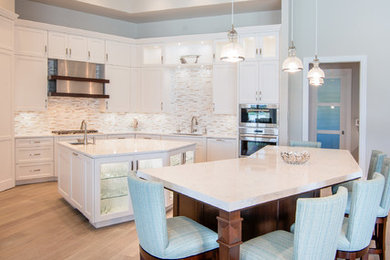 Inspiration for a transitional kitchen remodel in Miami with granite countertops and two islands