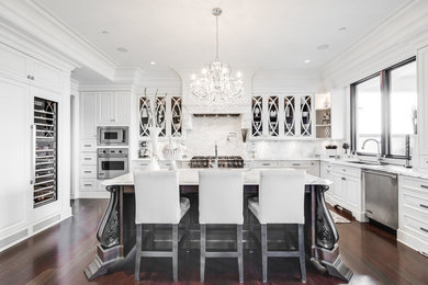 Example of a large classic open concept kitchen design in Vancouver with raised-panel cabinets, white cabinets, marble countertops and an island