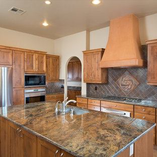 Inspiration for a southwestern ceramic tile kitchen remodel in Austin with ceramic backsplash, stainless steel appliances and an island