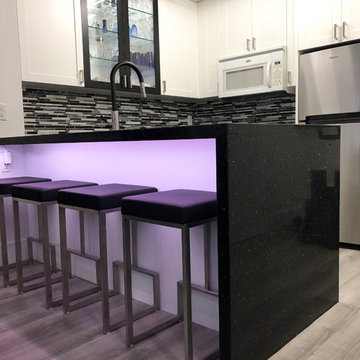 Custom shaker-style kitchen with waterfall countertop in Toronto