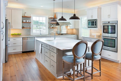 Transitional kitchen photo in Nashville with shaker cabinets and an island