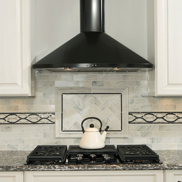 Custom Tiled Kitchen Backsplash with Black Range Hood
