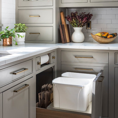 Large cottage l-shaped medium tone wood floor and brown floor kitchen photo in New York with a double-bowl sink, beige cabinets, quartz countertops, white backsplash, ceramic backsplash, black appliances, white countertops and recessed-panel cabinets