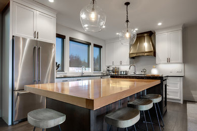 Стильный дизайн: кухня в стиле неоклассика (современная классика) с обеденным столом, фасадами в стиле шейкер, темными деревянными фасадами и островом - последний тренд