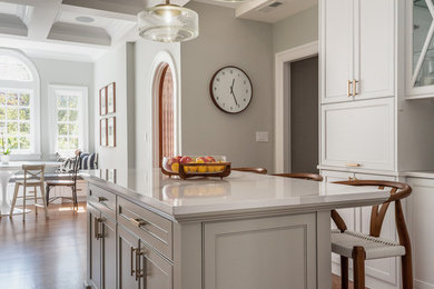 Inspiration for a large coastal u-shaped dark wood floor and brown floor eat-in kitchen remodel in Providence with an undermount sink, shaker cabinets, white cabinets, quartz countertops, white backsplash, glass tile backsplash, paneled appliances, an island and white countertops