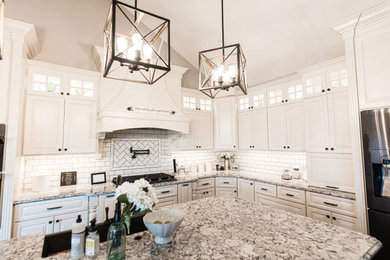 Large elegant u-shaped dark wood floor and brown floor eat-in kitchen photo in St Louis with an undermount sink, shaker cabinets, white cabinets, granite countertops, white backsplash, subway tile backsplash, stainless steel appliances, an island and multicolored countertops
