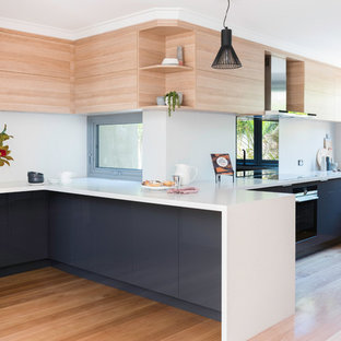 Photo of a large scandinavian kitchen in Perth with light wood cabinets, quartz benchtops and light hardwood floors.