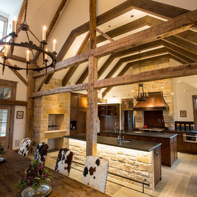 Example of a huge mountain style eat-in kitchen design in Dallas with dark wood cabinets