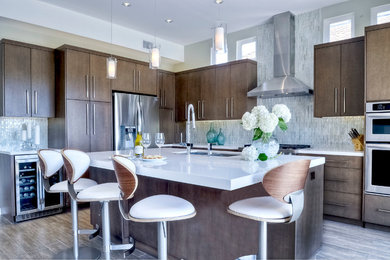 Eat-in kitchen - contemporary l-shaped porcelain tile eat-in kitchen idea in San Diego with an undermount sink, flat-panel cabinets, gray cabinets, quartz countertops, white backsplash, stainless steel appliances and an island