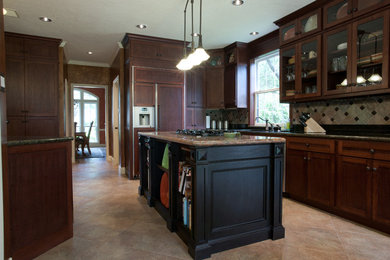 Eat-in kitchen - craftsman galley eat-in kitchen idea in Houston with an undermount sink, shaker cabinets, dark wood cabinets, granite countertops, mosaic tile backsplash and stainless steel appliances