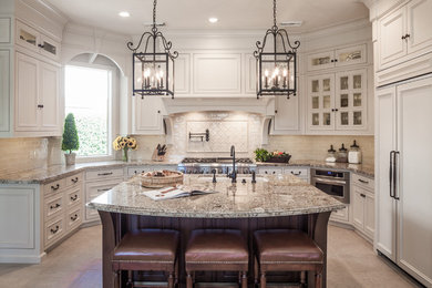 Elegant u-shaped eat-in kitchen photo in Houston with an undermount sink, beaded inset cabinets, beige cabinets, granite countertops, beige backsplash and stainless steel appliances