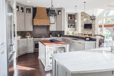Trendy u-shaped eat-in kitchen photo in Houston with an undermount sink, recessed-panel cabinets, gray cabinets, marble countertops, gray backsplash and stainless steel appliances