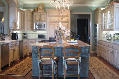 Example of a large classic u-shaped dark wood floor eat-in kitchen design in Oklahoma City with a double-bowl sink, raised-panel cabinets, beige cabinets, granite countertops, stone tile backsplash, stainless steel appliances and an island