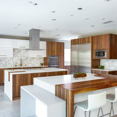 Eat-in kitchen - huge modern l-shaped porcelain tile and gray floor eat-in kitchen idea in Dallas with a single-bowl sink, flat-panel cabinets, medium tone wood cabinets, quartz countertops, gray backsplash, marble backsplash, stainless steel appliances, two islands and white countertops