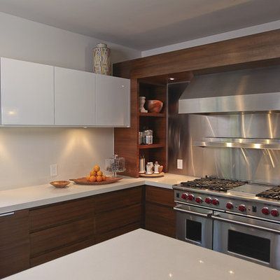 Example of a trendy kitchen design in Dallas with stainless steel appliances, flat-panel cabinets, dark wood cabinets, metallic backsplash and metal backsplash