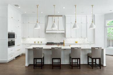 Large transitional l-shaped dark wood floor and brown floor eat-in kitchen photo in Dallas with an undermount sink, recessed-panel cabinets, white cabinets, quartz countertops, white backsplash, quartz backsplash, stainless steel appliances, an island and white countertops