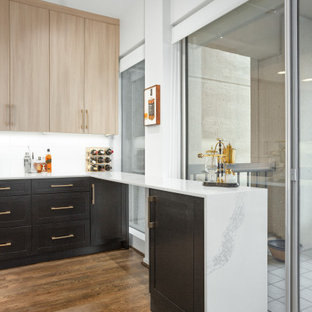 Small contemporary kitchen designs - Inspiration for a small contemporary medium tone wood floor and brown floor kitchen remodel in Dallas with an undermount sink, shaker cabinets, black cabinets, quartz countertops, white backsplash, ceramic backsplash, stainless steel appliances and white countertops