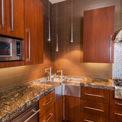 Example of a trendy galley eat-in kitchen design in Dallas with a farmhouse sink, flat-panel cabinets, medium tone wood cabinets, granite countertops, metallic backsplash, stainless steel appliances and glass tile backsplash