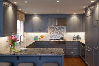 Example of a transitional u-shaped medium tone wood floor kitchen design in San Francisco with an undermount sink, recessed-panel cabinets, gray cabinets, granite countertops, white backsplash, mosaic tile backsplash and stainless steel appliances