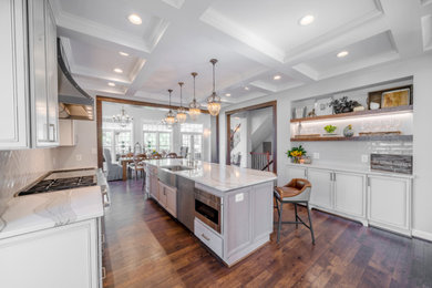 Example of a large transitional eat-in kitchen design in DC Metro with white cabinets, granite countertops, white backsplash, an island and white countertops