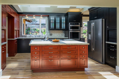 Eat-in kitchen - mid-sized eclectic u-shaped porcelain tile eat-in kitchen idea in Other with an undermount sink, beaded inset cabinets, black cabinets, granite countertops, metallic backsplash, metal backsplash, stainless steel appliances and an island