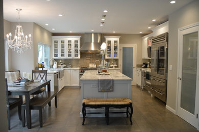 Example of a large transitional porcelain tile and gray floor kitchen pantry design in San Francisco with a farmhouse sink, recessed-panel cabinets, white cabinets, marble countertops, gray backsplash, glass tile backsplash, stainless steel appliances, an island and gray countertops