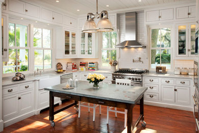 Eat-in kitchen - large transitional u-shaped medium tone wood floor eat-in kitchen idea in Atlanta with a farmhouse sink, beaded inset cabinets, white cabinets, marble countertops, white backsplash, ceramic backsplash, stainless steel appliances and an island