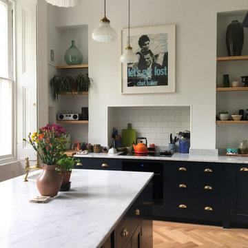 Dark blue traditional hand painted kitchen with open plan shelving, large island