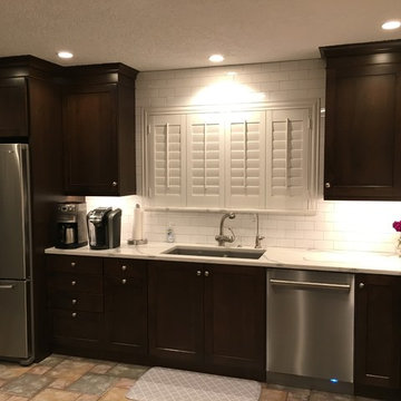 Dark Dramatic Kitchen with Shaker Style Cabinets & White Subway Tile