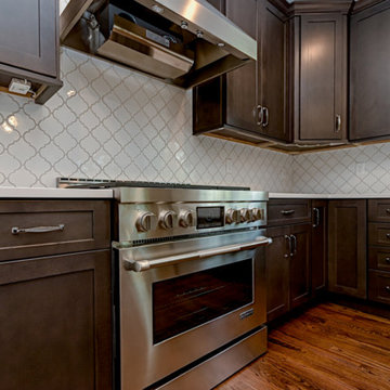 Dark Stained Kitchen Cabinets With White Backsplash