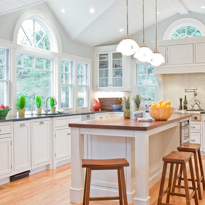 Elegant kitchen photo in Boston with beaded inset cabinets, wood countertops, white cabinets, white backsplash and subway tile backsplash