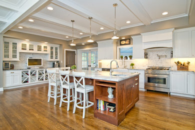 Eat-in kitchen - large transitional l-shaped medium tone wood floor eat-in kitchen idea in Baltimore with a farmhouse sink, shaker cabinets, white cabinets, marble countertops, white backsplash, stone tile backsplash, stainless steel appliances and an island