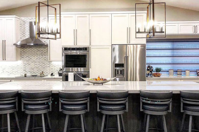 Eat-in kitchen - large transitional porcelain tile and beige floor eat-in kitchen idea in Miami with a farmhouse sink, shaker cabinets, white cabinets, quartz countertops, multicolored backsplash, marble backsplash, stainless steel appliances, an island and white countertops