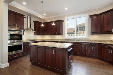 Inspiration for a mid-sized timeless u-shaped eat-in kitchen remodel in Other with raised-panel cabinets and an island