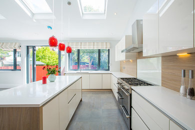 Photo of a contemporary kitchen in London with grey floors.